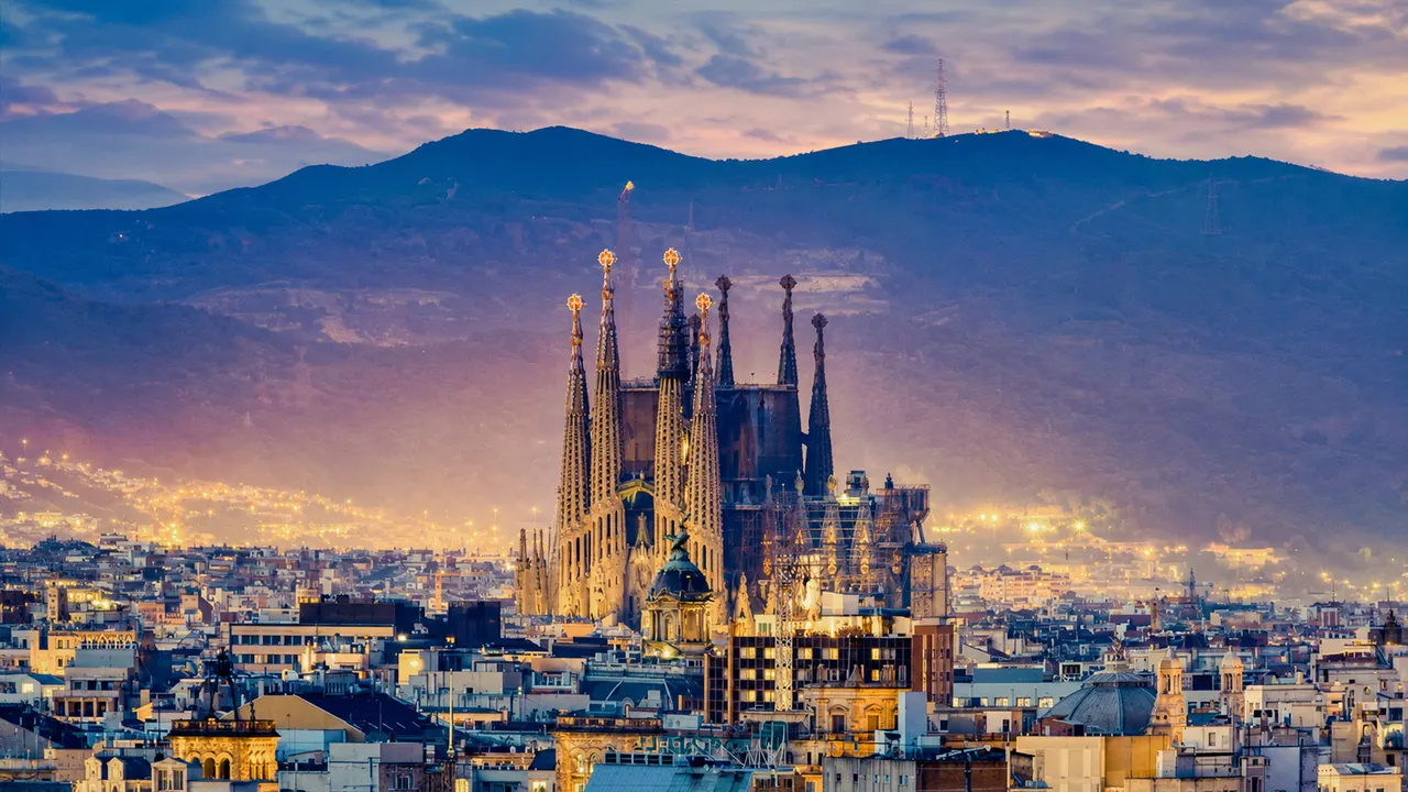 The Sagrada Familia above the Barcelona skyline at dusk