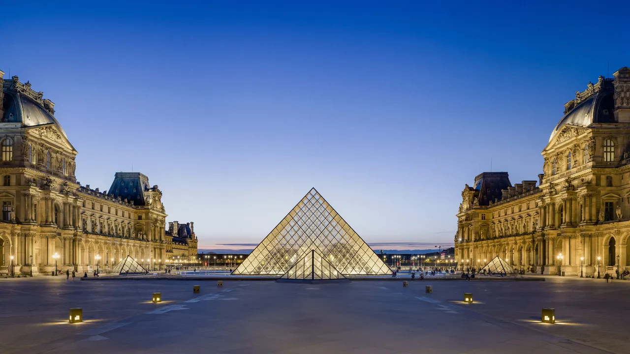 The Louvre courtyard and glass pyramid at dusk, Paris